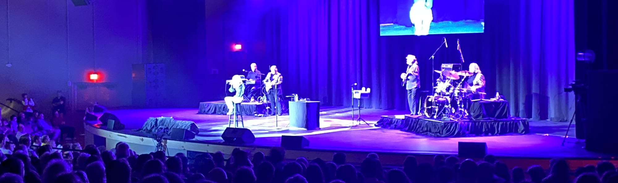 signer on stage in chair washed out by the lights Orlando