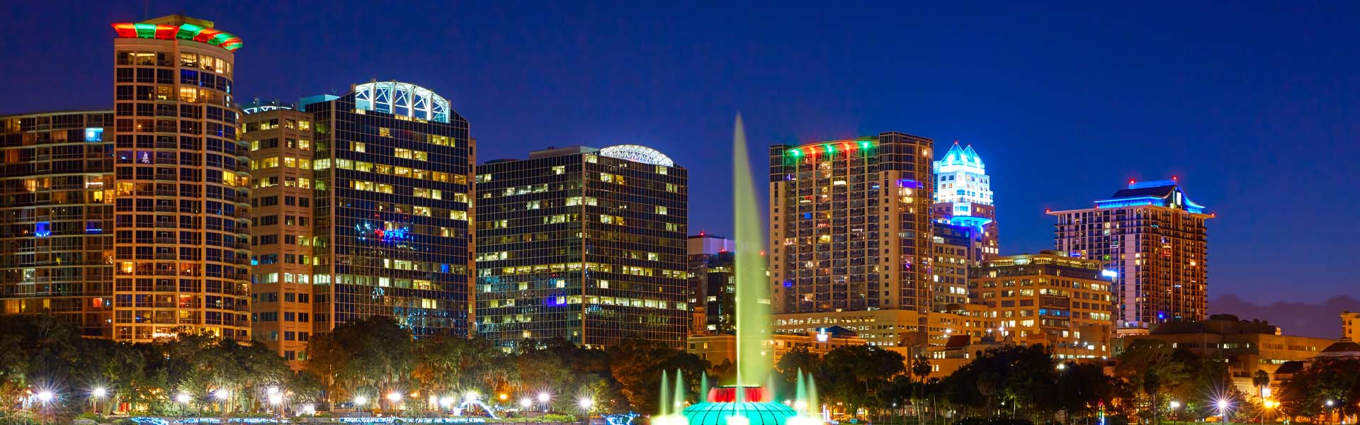 Neon color image of a band playing and people singing along
